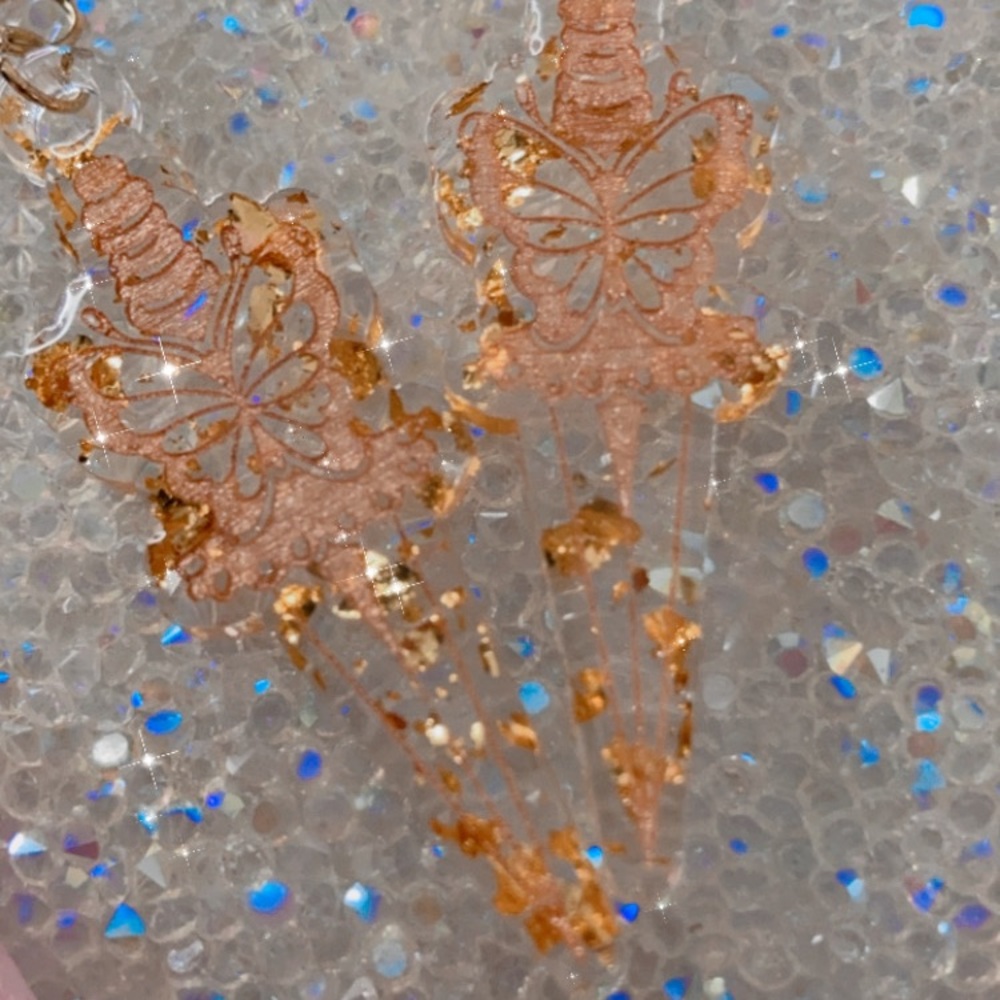Gold flake butterfly dagger earrings